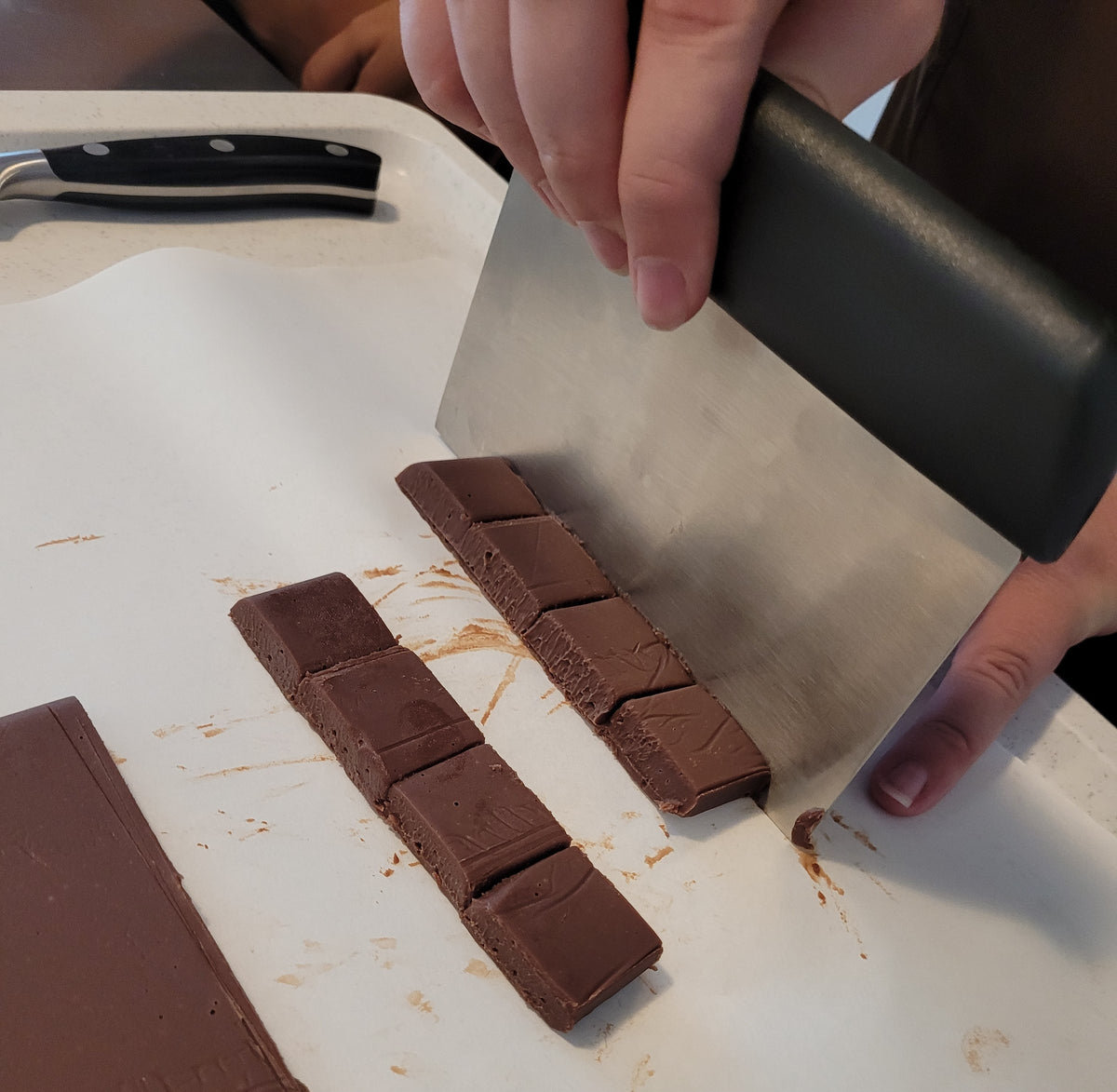 Ganache wird mit der Teigkarte in Pralinenwürfel geschnitten